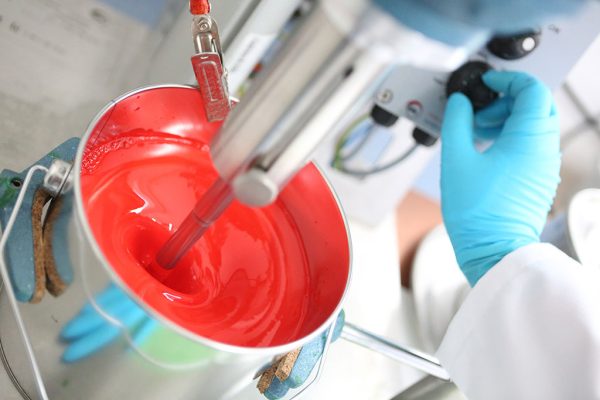 Rote Farbe im Mischer – Dreisol Coatings stellt hochwertige Lacke mit exakter Farbzusammenstellung und Mischtechnik her